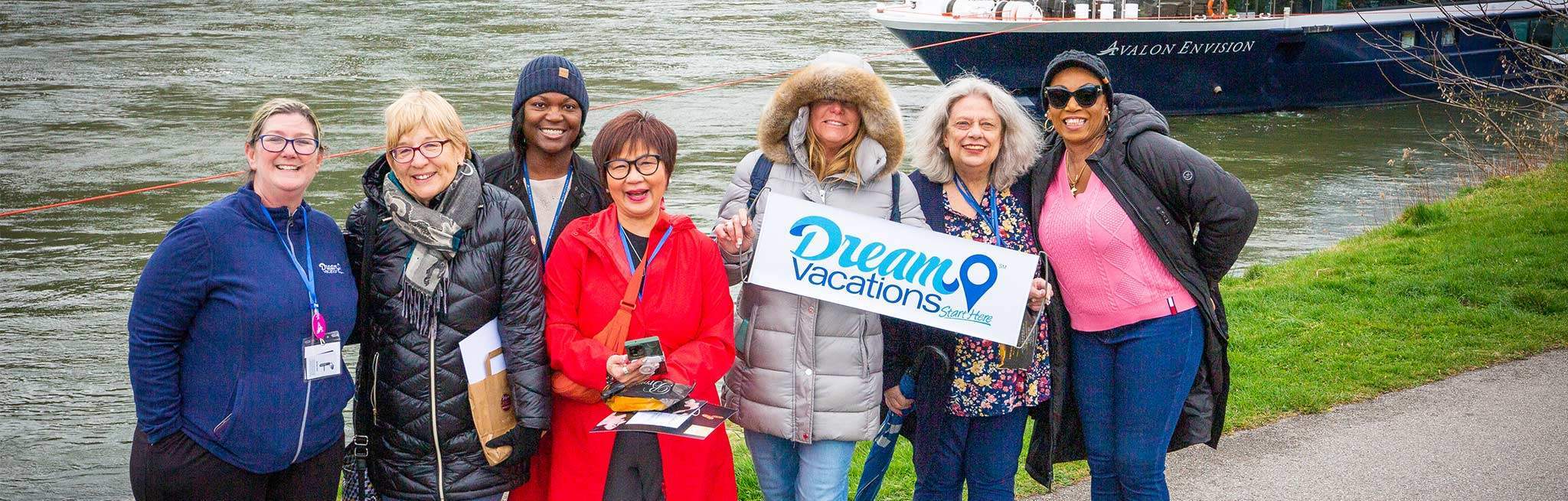 Seven Dream Vacations franchisees standing near a river