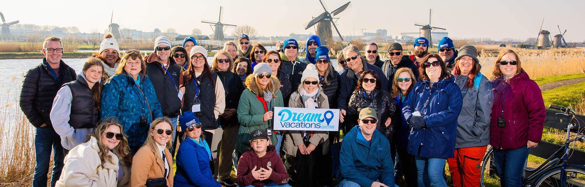 Dream Vacations franchisees outdoors near several windmills