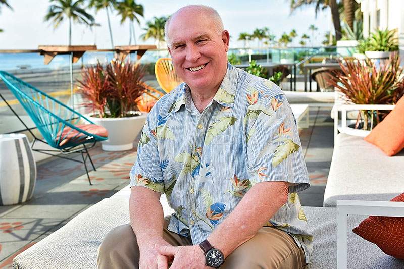 man sitting on a pool chair