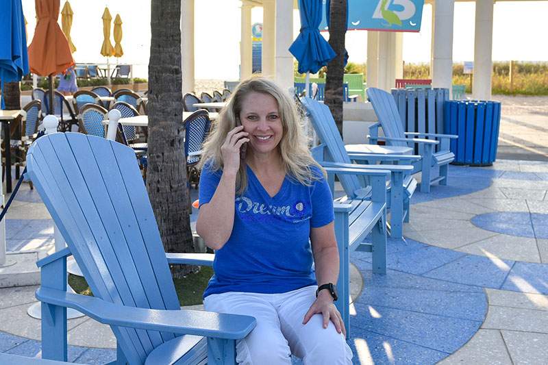 advisor on an adirondack chair on the phone